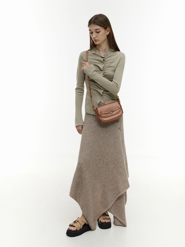 A compact-sized saddle crossbody bag in brown exudes a vintage-inspired charm
