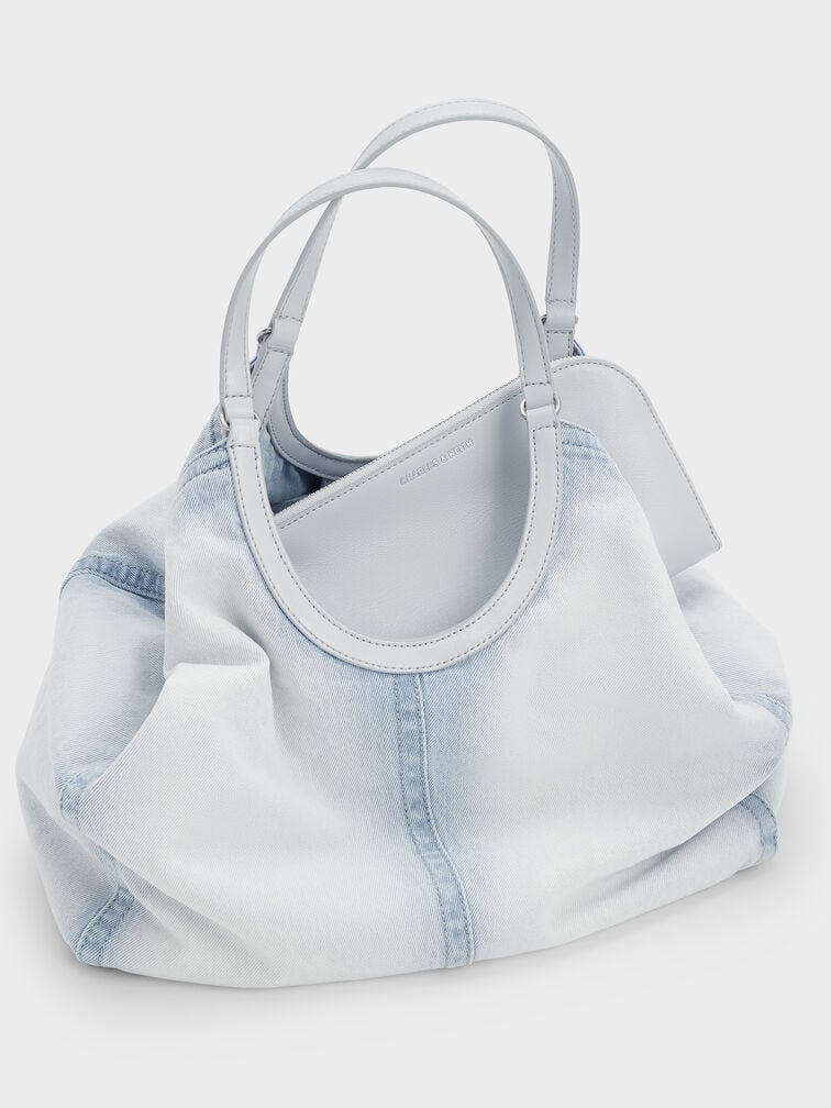 Casual denim tote bag with a slouchy silhouette and roomy interior, perfect for a sporty lifestyle.