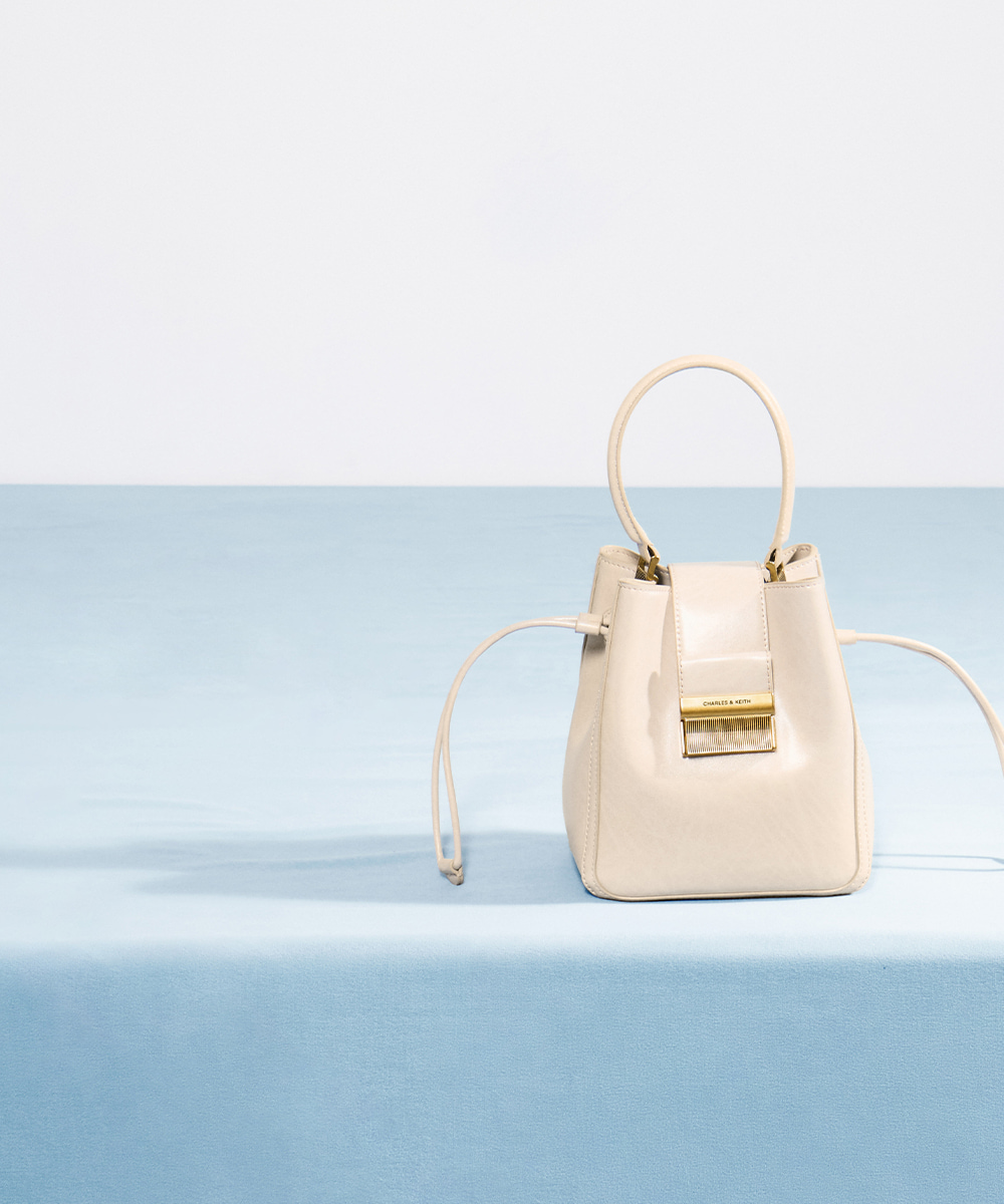 Women’s Charlot elongated bucket bag in oat – CHARLES & KEITH