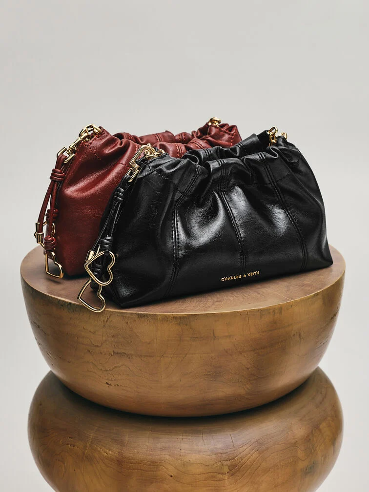 A slouchy crossbody bag showcasing the ruched details and relaxed shape