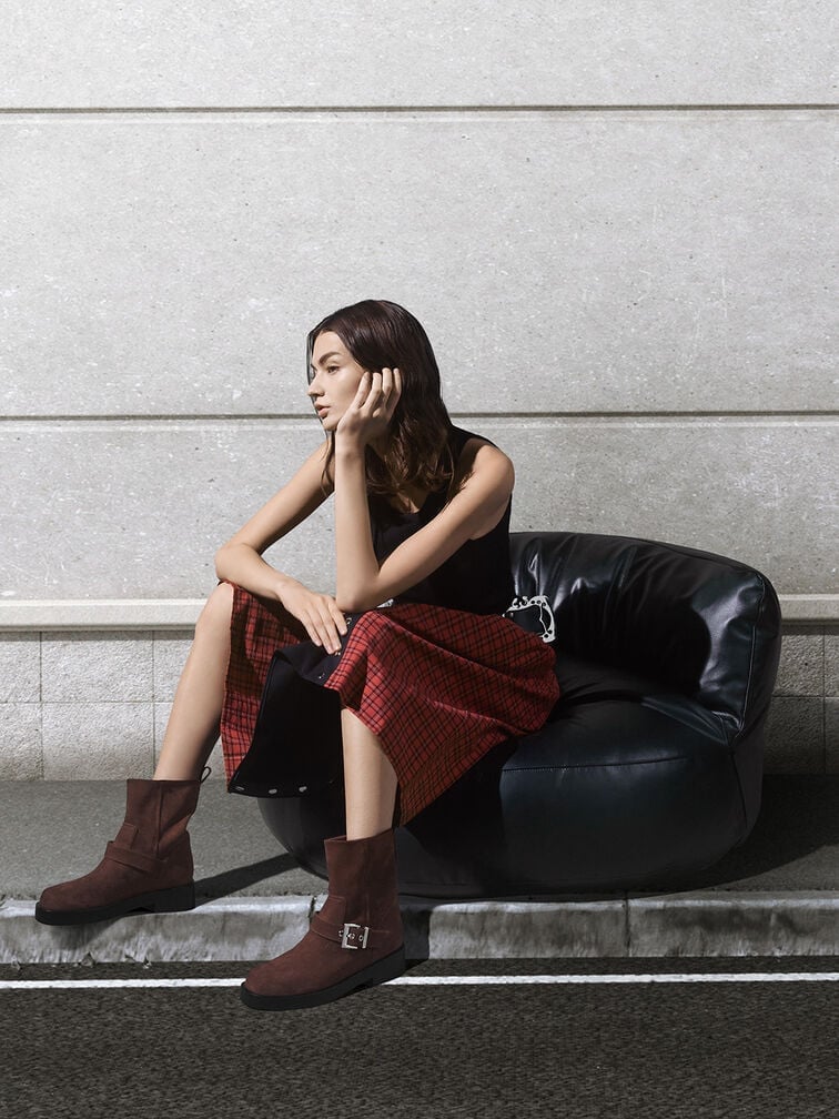 Brown biker boots styled with a red dress.