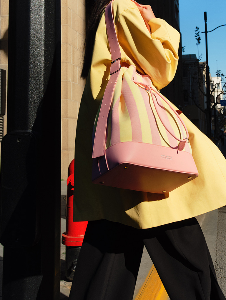 Women’s striped bucket bag in yellow  from the Short Sentence x CHARLES & KEITH collection - CHARLES & KEITH