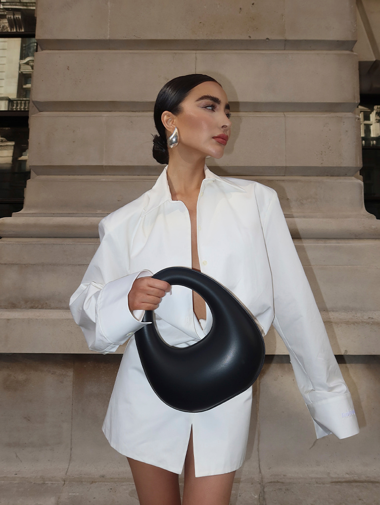 Women’s Petra curved shoulder bag and Pixie platform ankle boots in black, as seen on Izi Angus – CHARLES & KEITH