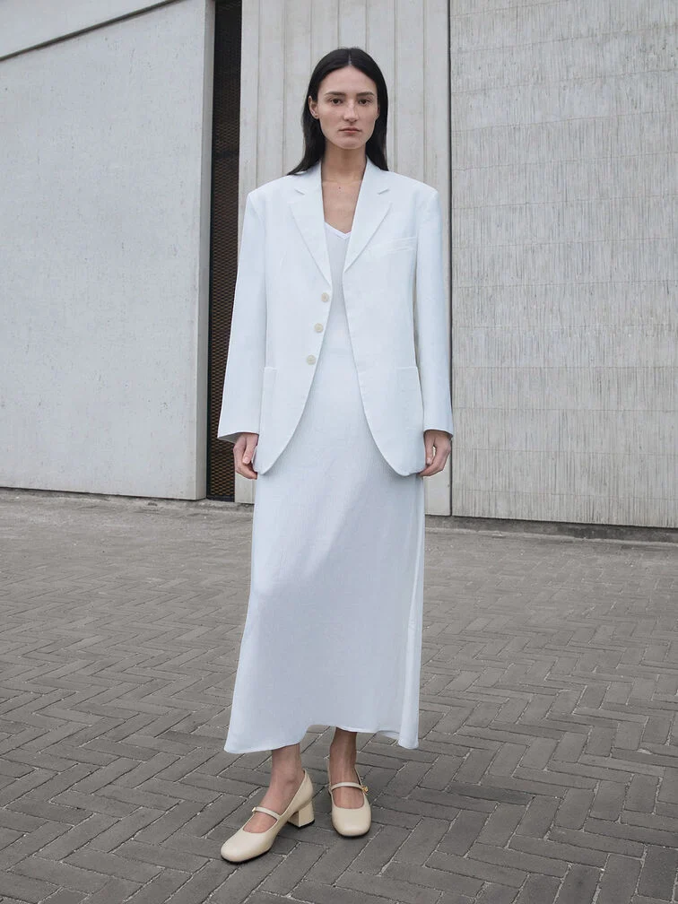 A blazer and satin slip dress in the exact same shade for a full winter white outfit.