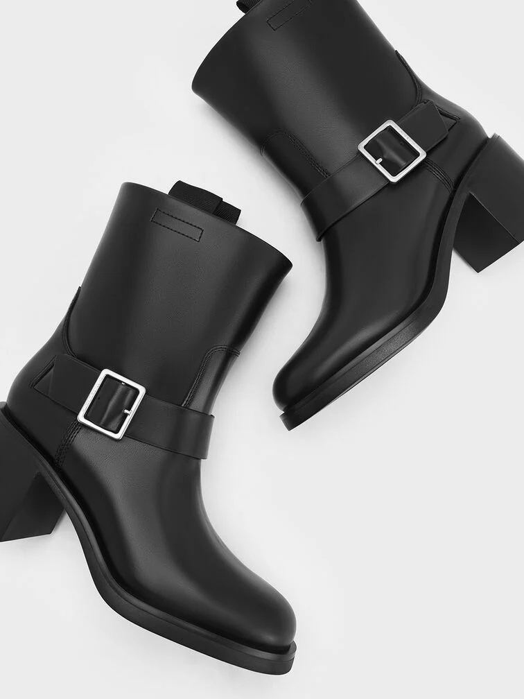 Heeled ankle boots with decorative buckled straps.