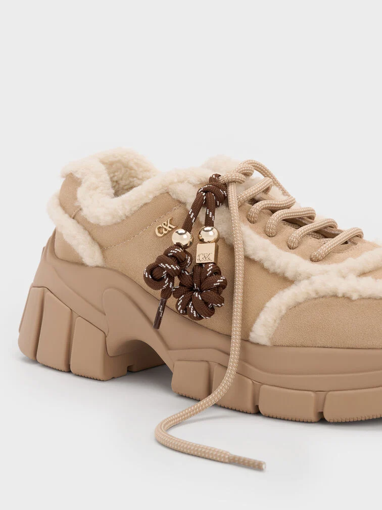 Masywne sneakersy o obszernej konstrukcji i grubych podeszwach zewnętrznych.  