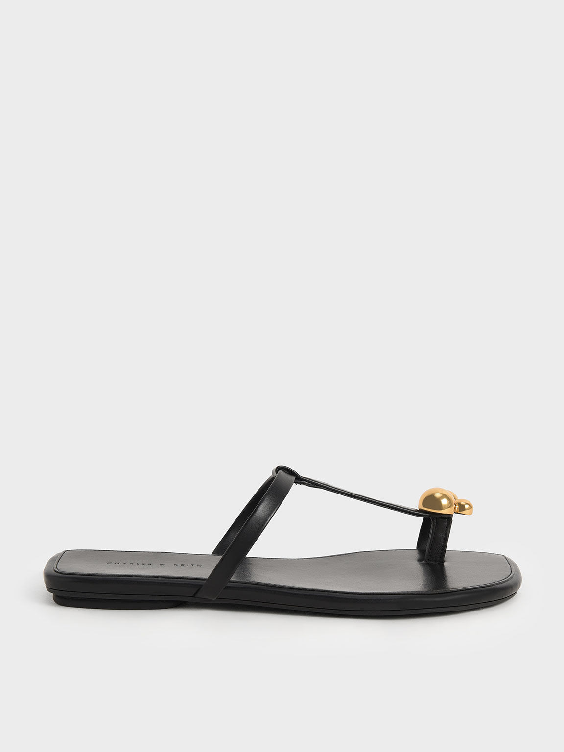 black and gold flat sandals